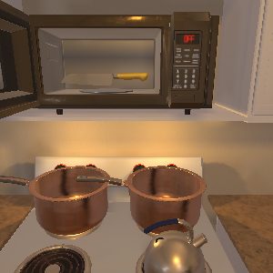 A simulated kitchen with a metal knife inside an open microwave, above a stove